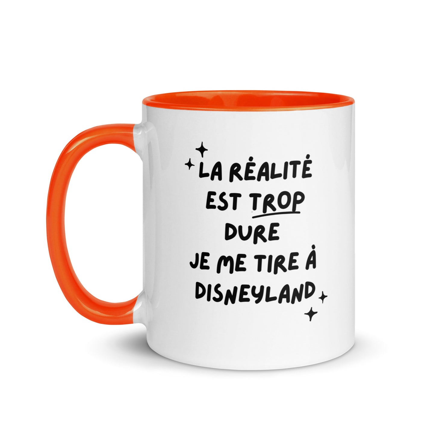 Tasse blanche brillante avec poignée, intérieur et rebord coloré orange avec inscription "La réalité est trop dure, je me tire à Disneyland"